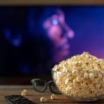 Bowl of popcorn in front of a TV