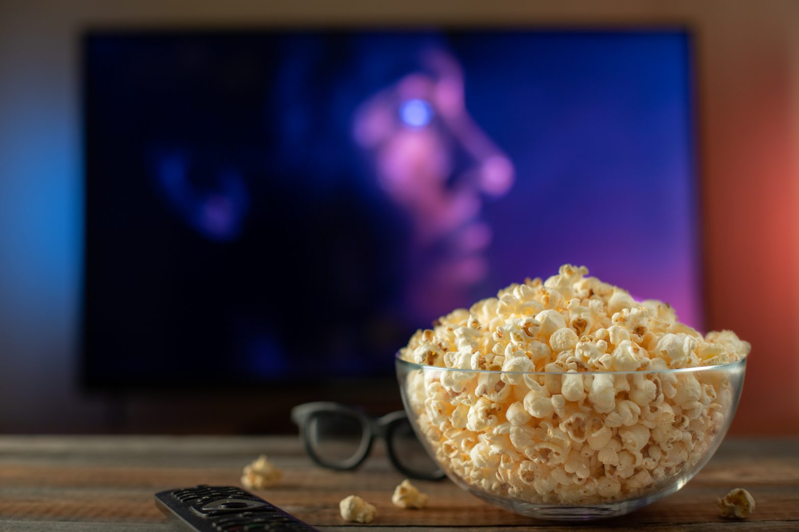 Bowl of popcorn in front of a TV