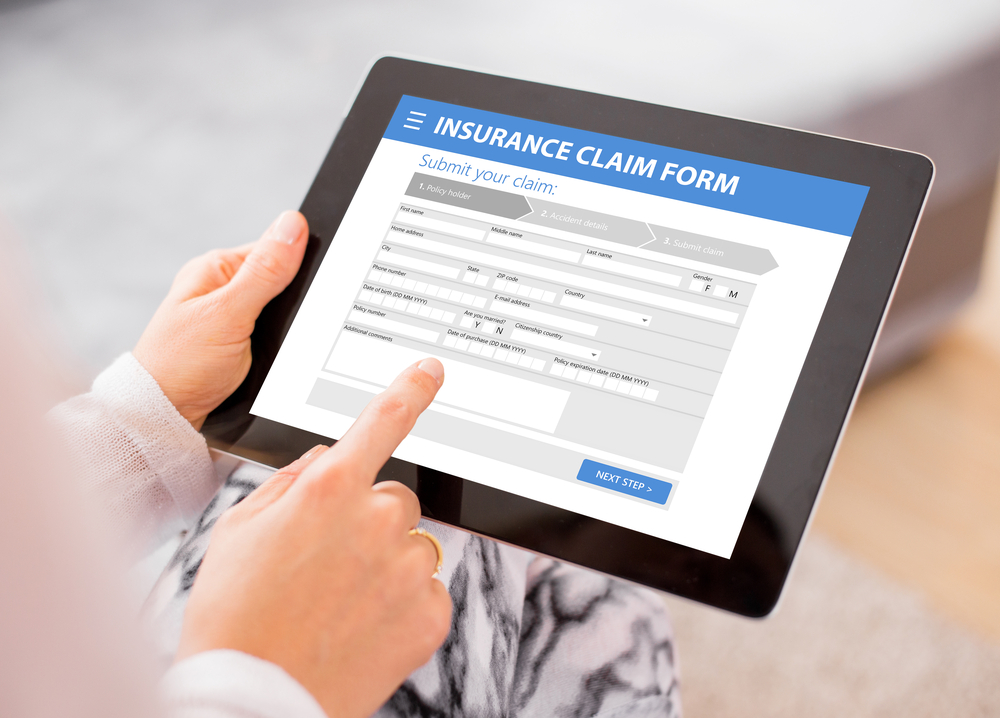 A person filling out a CPAP insurance claim form on a tablet.